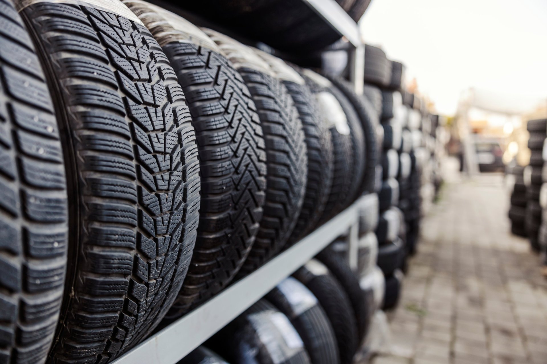 Close up of tires on rack in a row at mechanic workshop yard