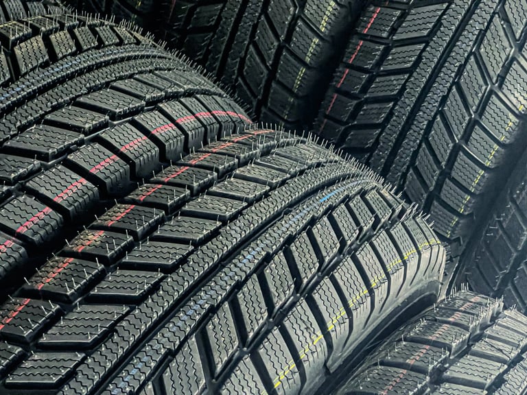 Stacked new tires showing detailed sidewall and manufacturing quality